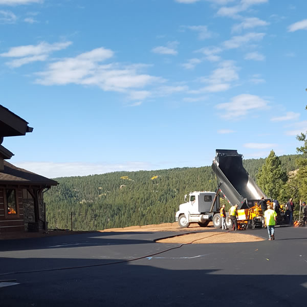 Long residential asphalt driveway through Colorado property
